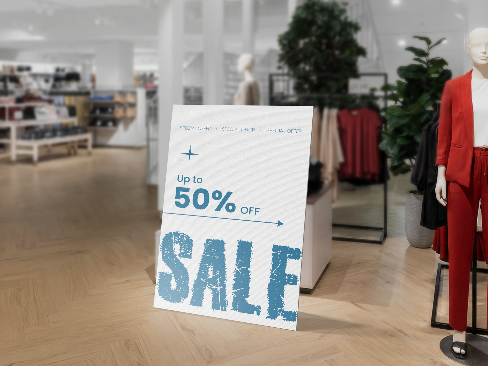 A sleek standee in a retail store announcing a fifty percent sale.
