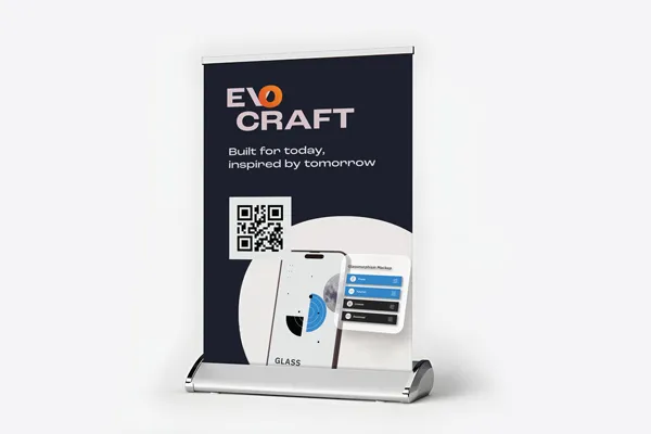 A tabletop retractable banner featuring a QR code and a mobile app design.