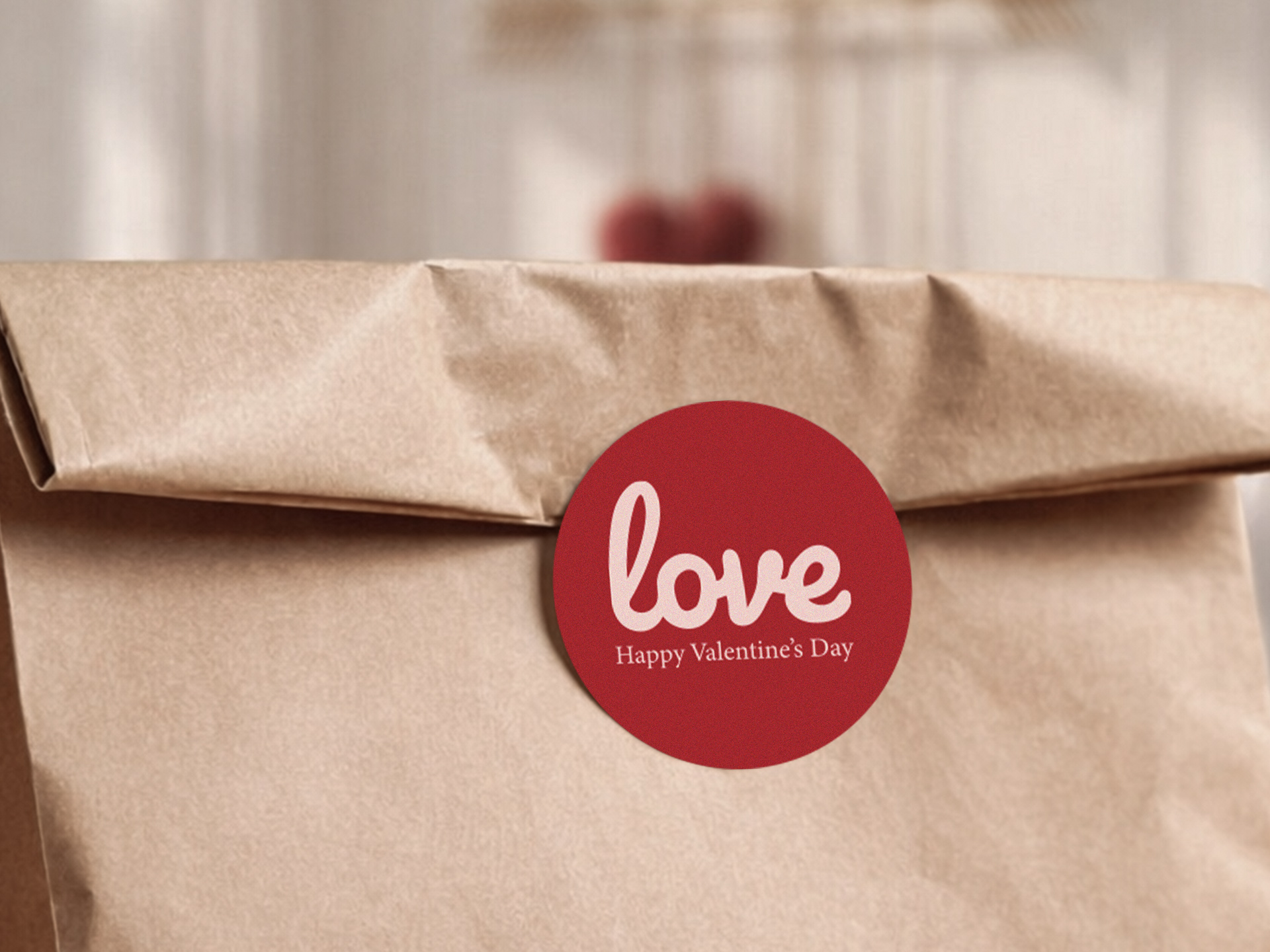 Valentine’s Day love sticker on brown paper packaging