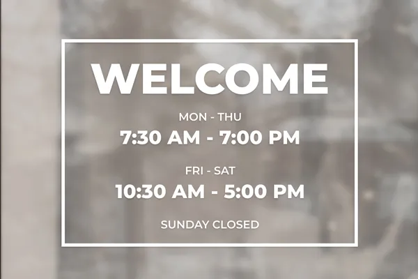 Welcoming vinyl lettering on the window featuring the business hours.