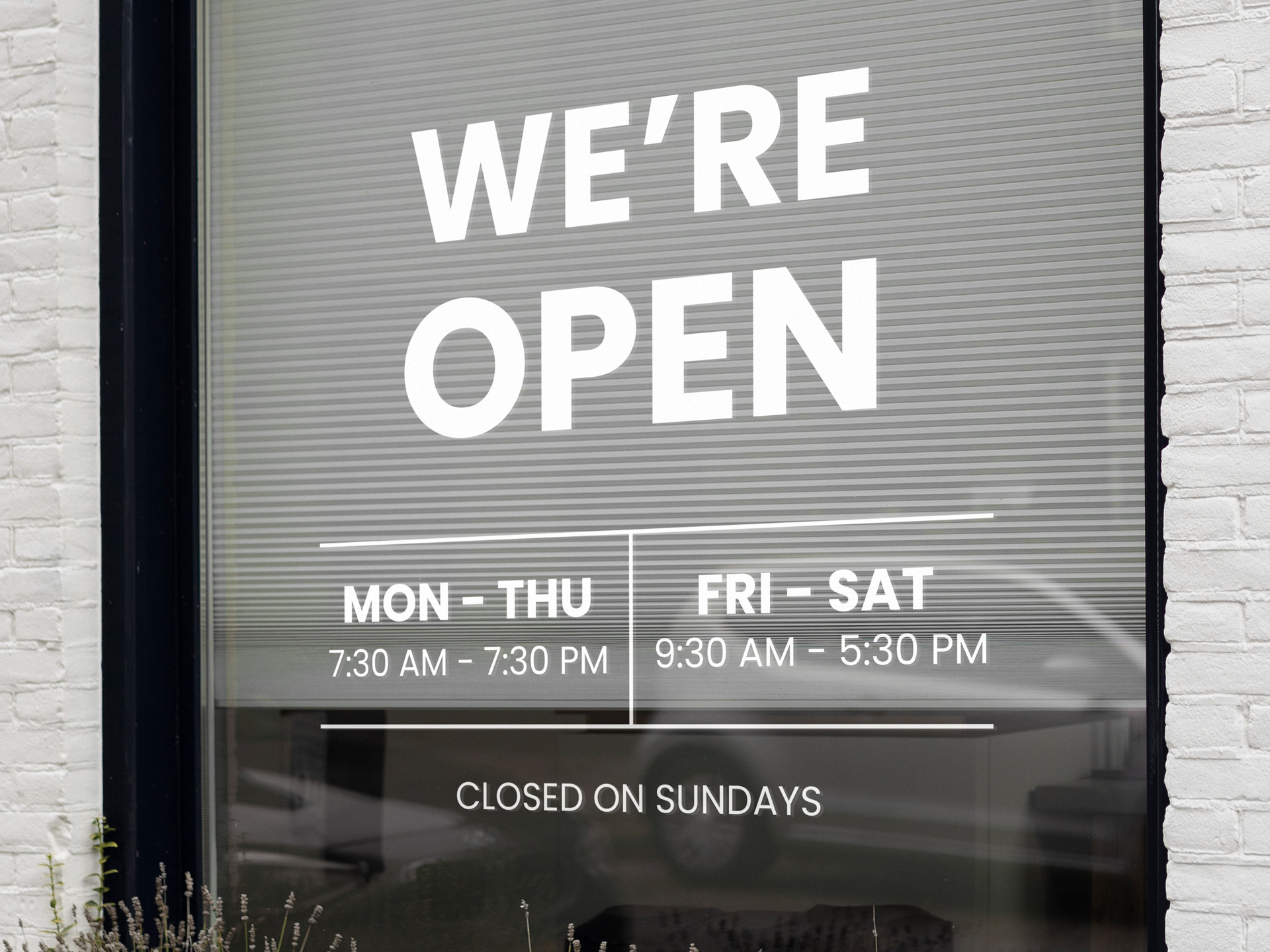 Vinyl lettering with We're Open message and working hours