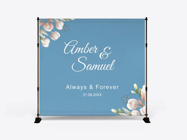 A blue custom wedding backdrop featuring the couple's names and wedding date.
