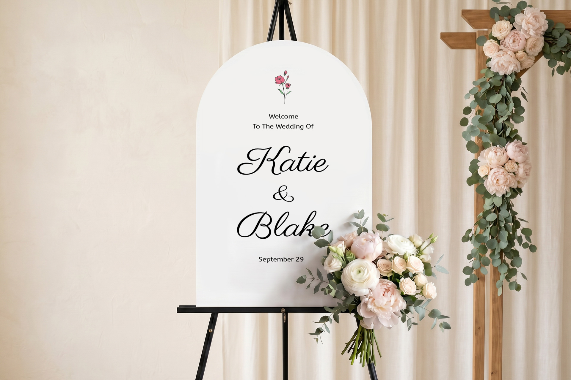 White arched foam board wedding sign on an easel for Katie and Blake decorated with flowers