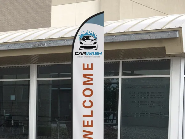 A custom feather flag used at a car wash to welcome customers.
