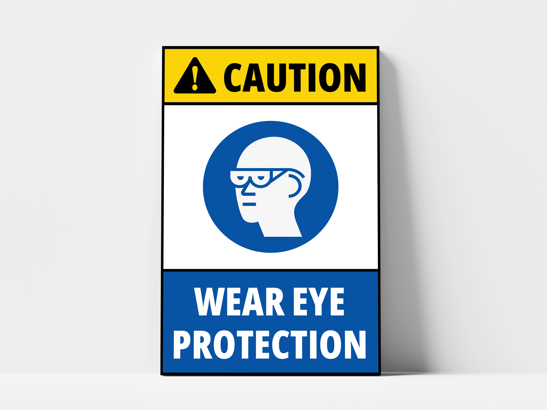 A workplace safety sign cautioning people in the area to wear eye protection.