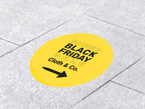 A Black Friday floor decal in yellow directing to Cloth & Co. store with arrow.