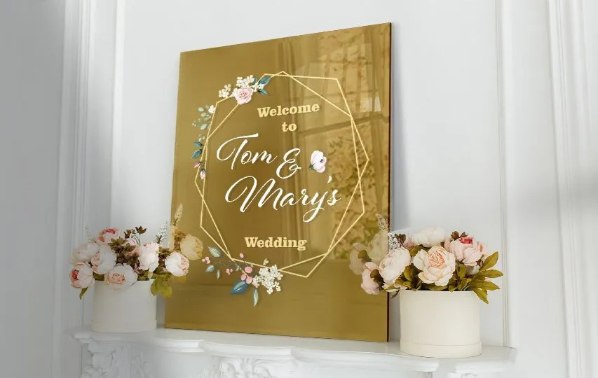 Welcome to Tom and Mary's Wedding gold acrylic greeting sign set up on a mantel.