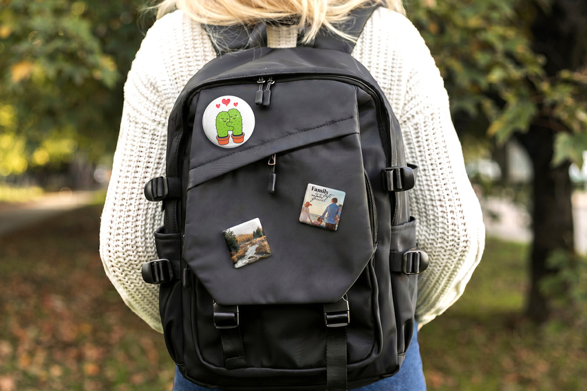 Pin buttons of different shapes on backpack