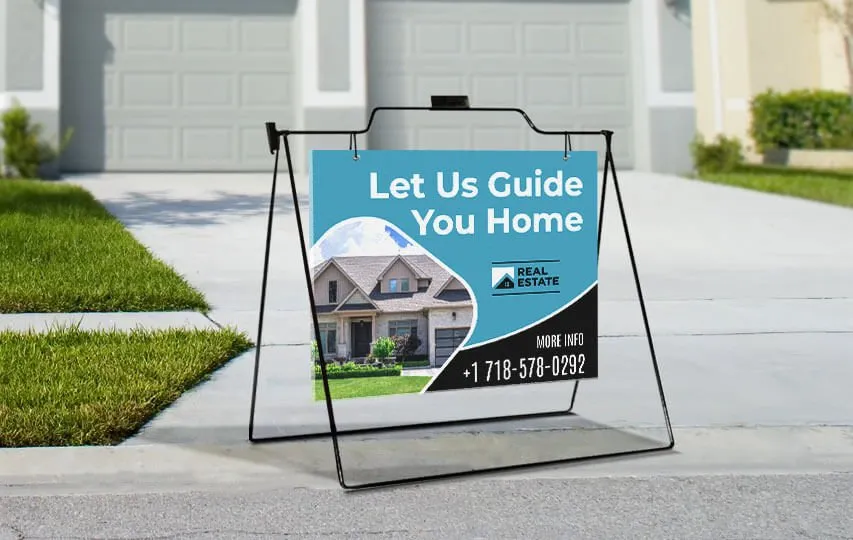 Real estate a frame signs reading Let Us Guide You Home.
