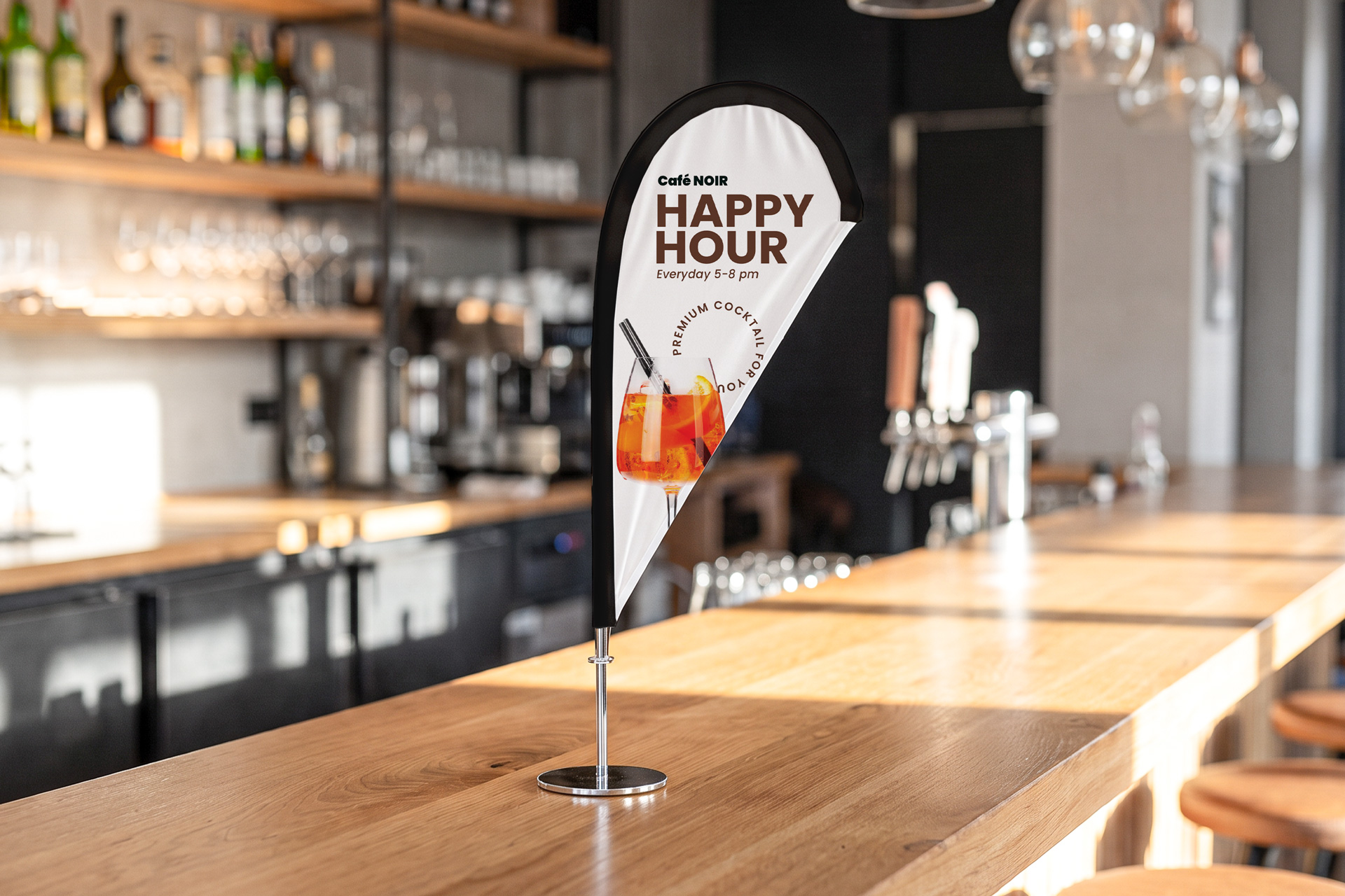Desktop teardrop flag banner installed in a cafe promoting happy hour.