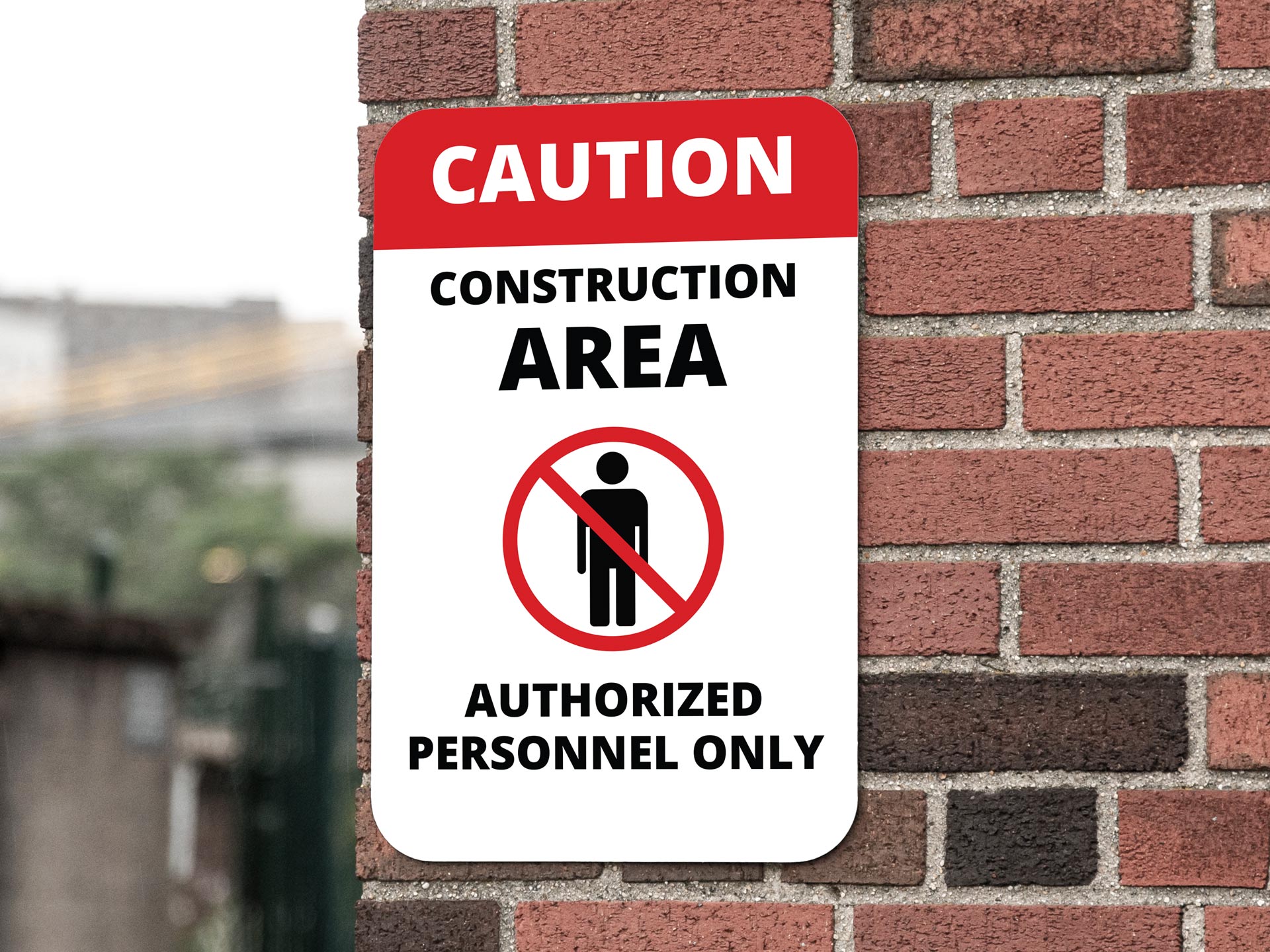 A black, red, and white construction area authorized personnel only construction sign.