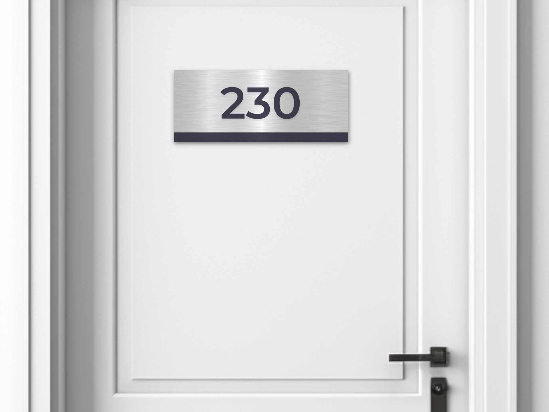 brushed-metal-custom-room-number-sign-mounted-on-a-white-door