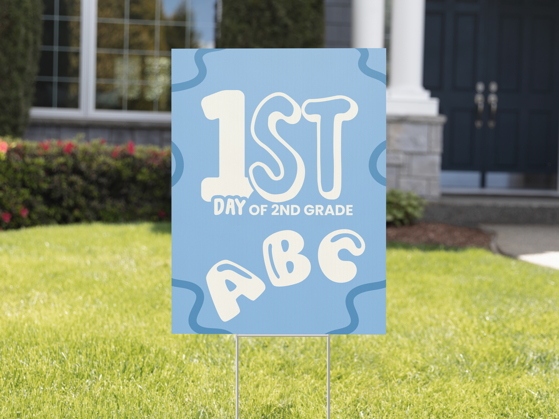 First day of school blue yard sign set up on a front lawn.