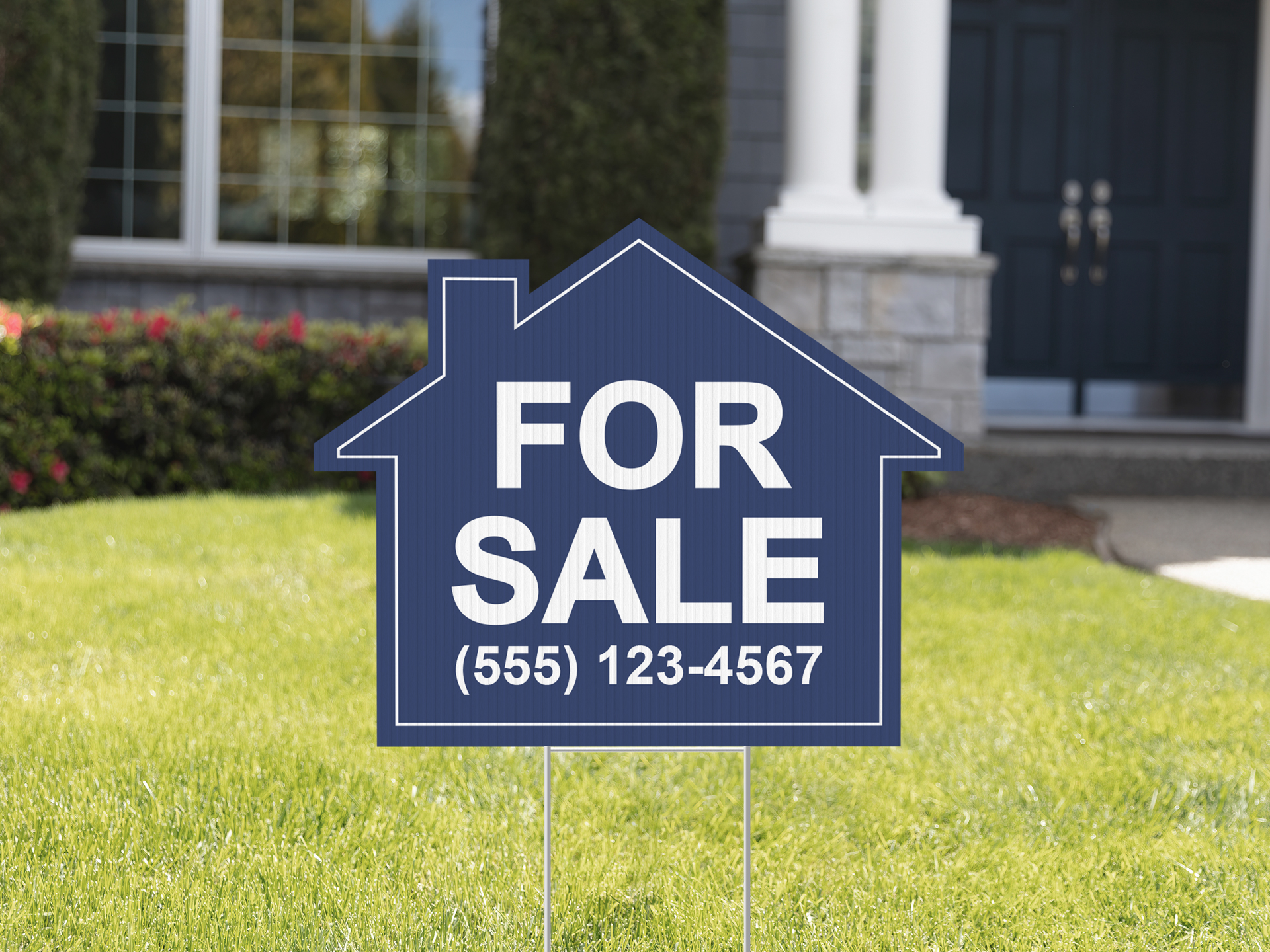 A For Sale yard sign with a custom house shape