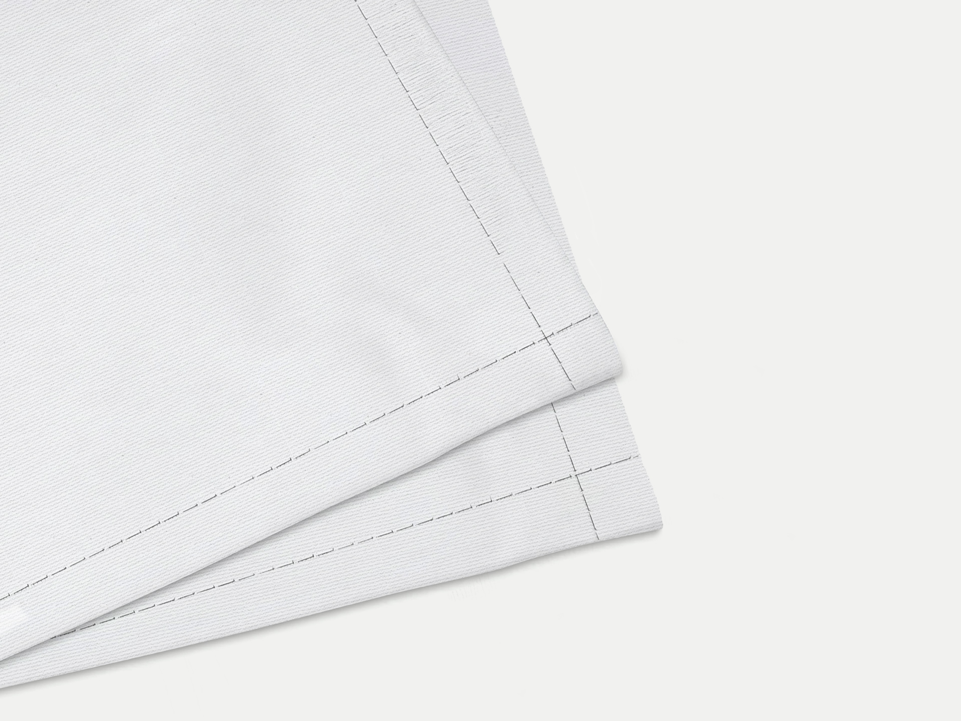 corner of a white flag with finished, stitched hem detail