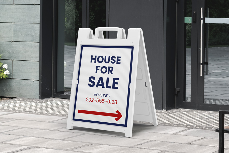 House For Sale white sandwich board displaying the contact info and a navigational arrow.