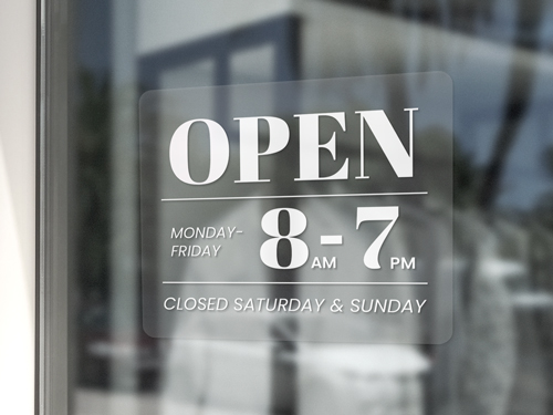Clear window cling showcasing the operating hours of the business.