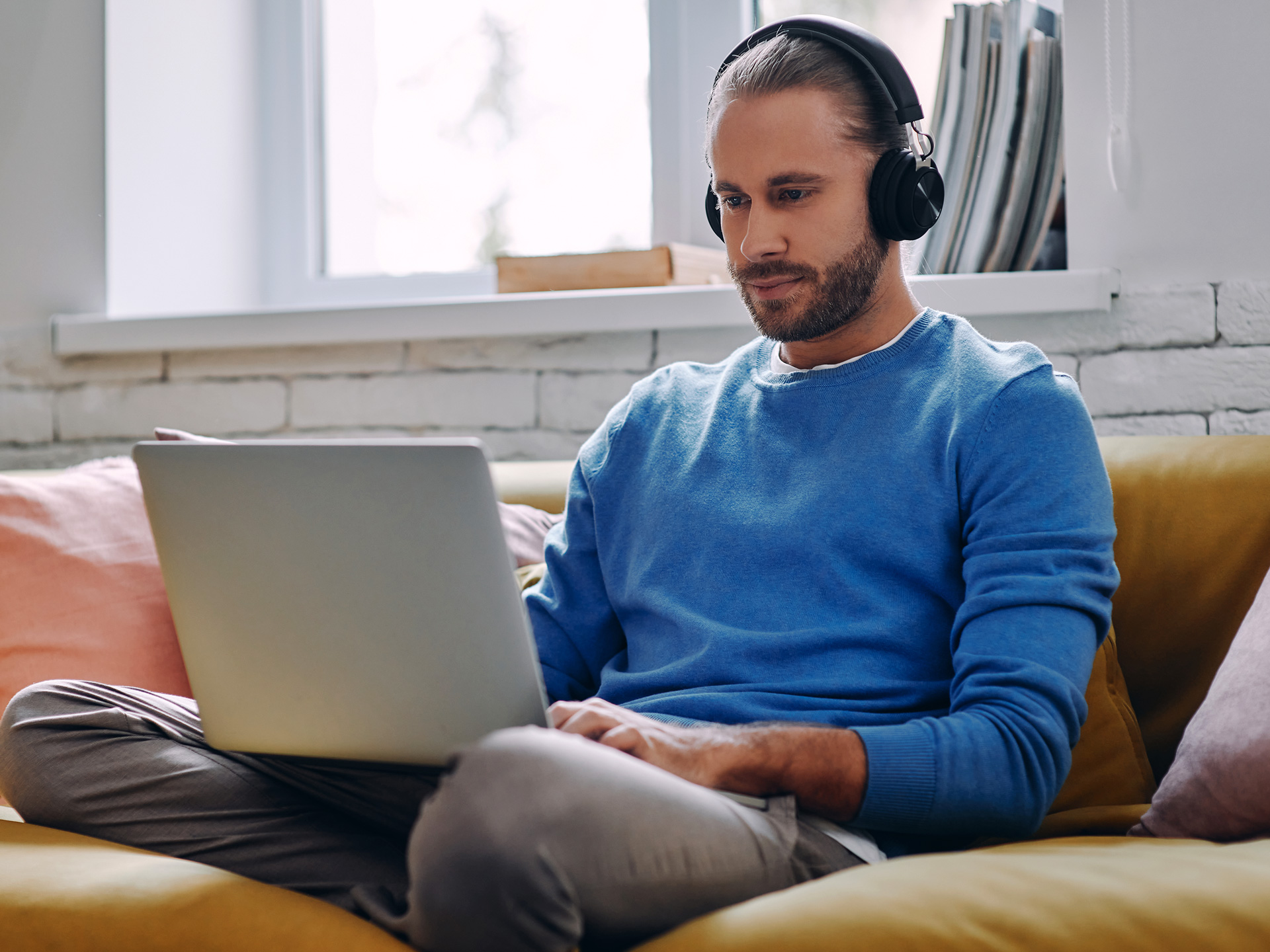 man-with-headphones-working-on-laptop