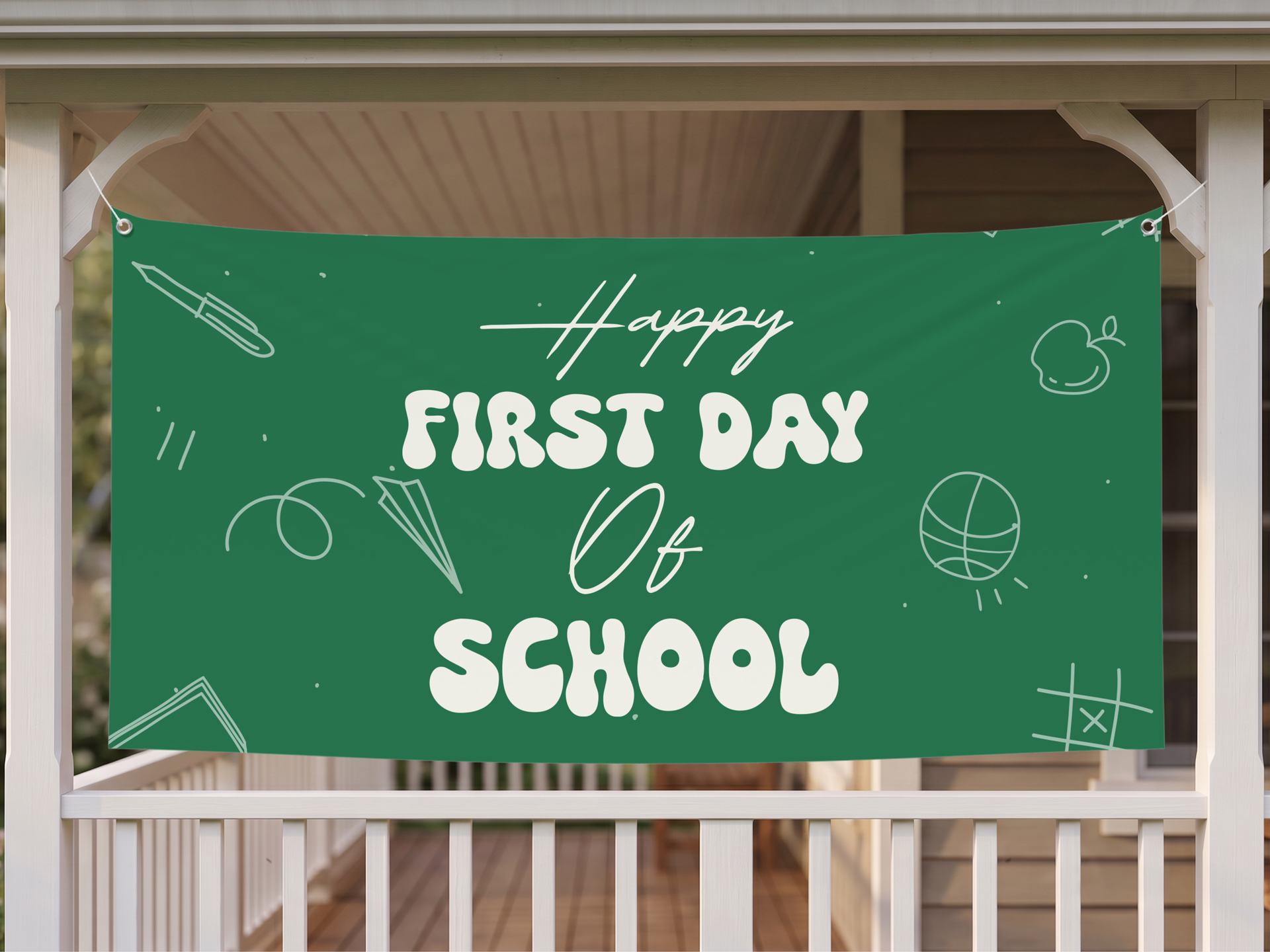 Happy first day of school green vinyl banner outdoors.