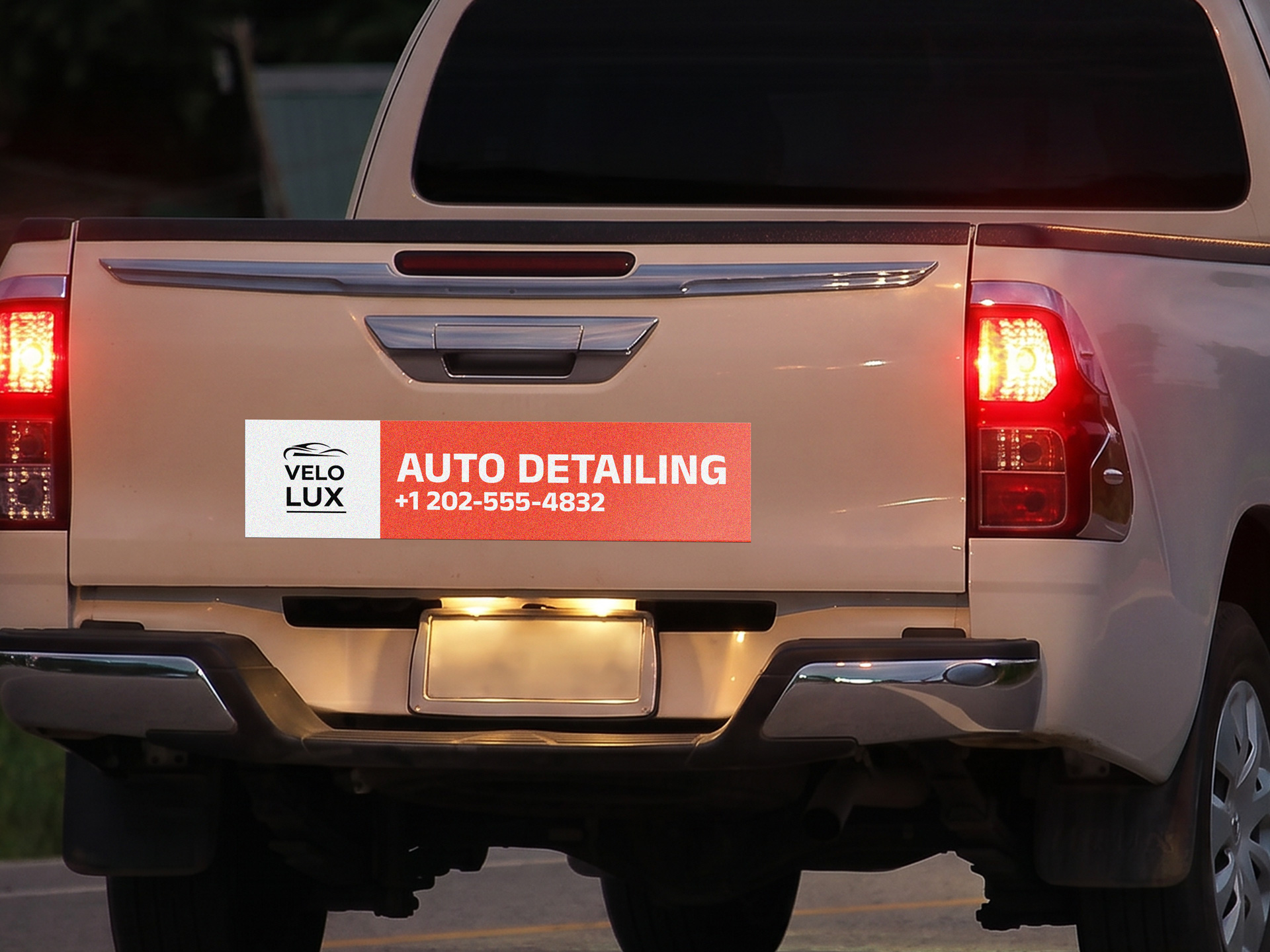 Reflective vehicle graphics promoting an auto detailing business.