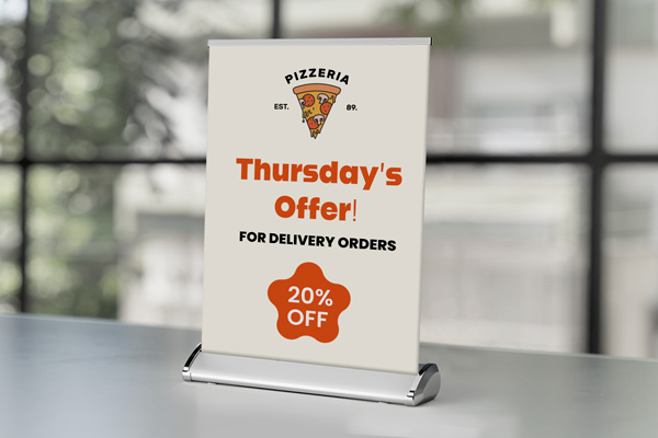 Tabletop retractable banner advertising menu specials on a restaurant counter.