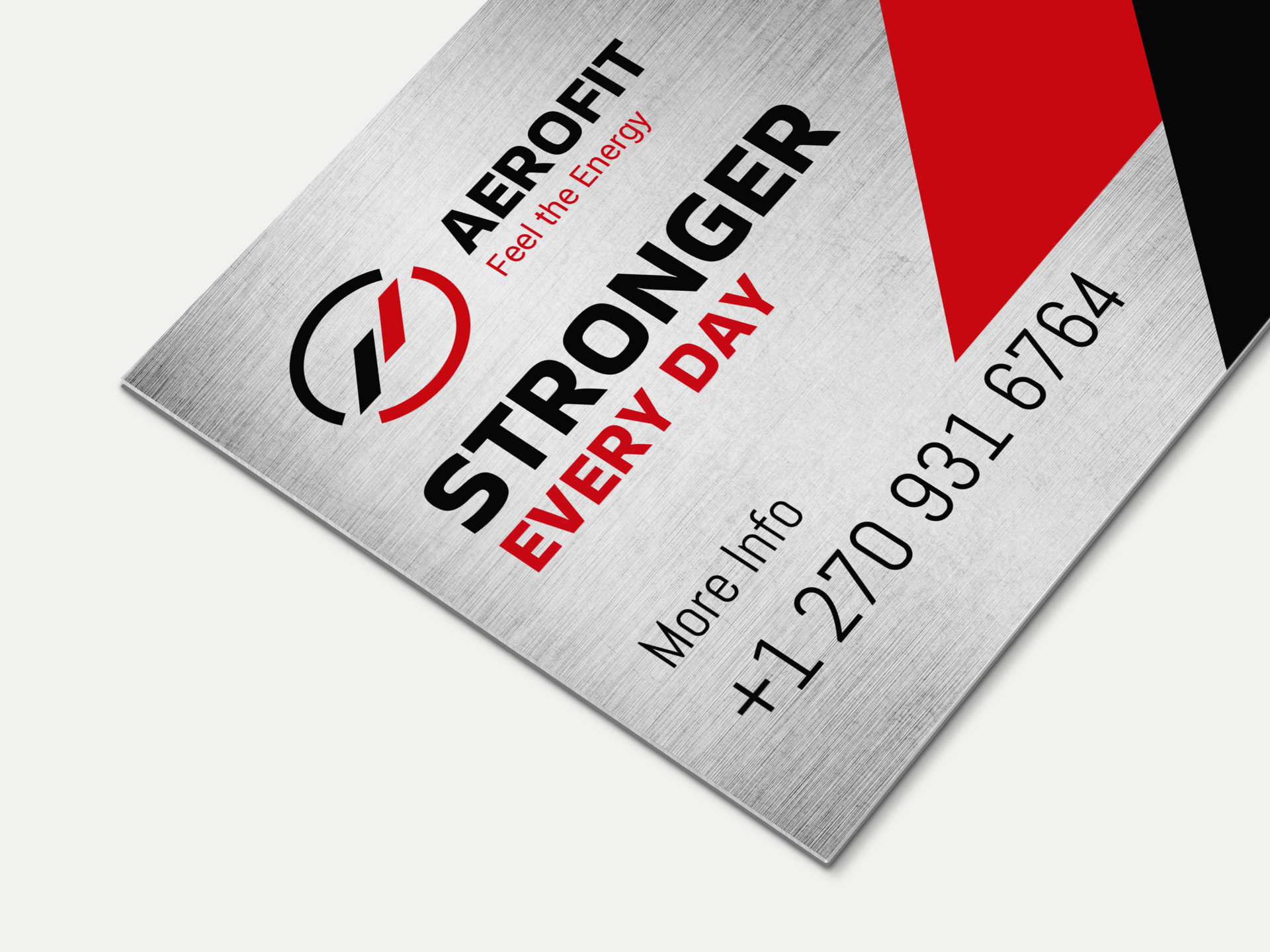 Brushed aluminum sign featuring fitness club logo, promotional messaging and contact information.
