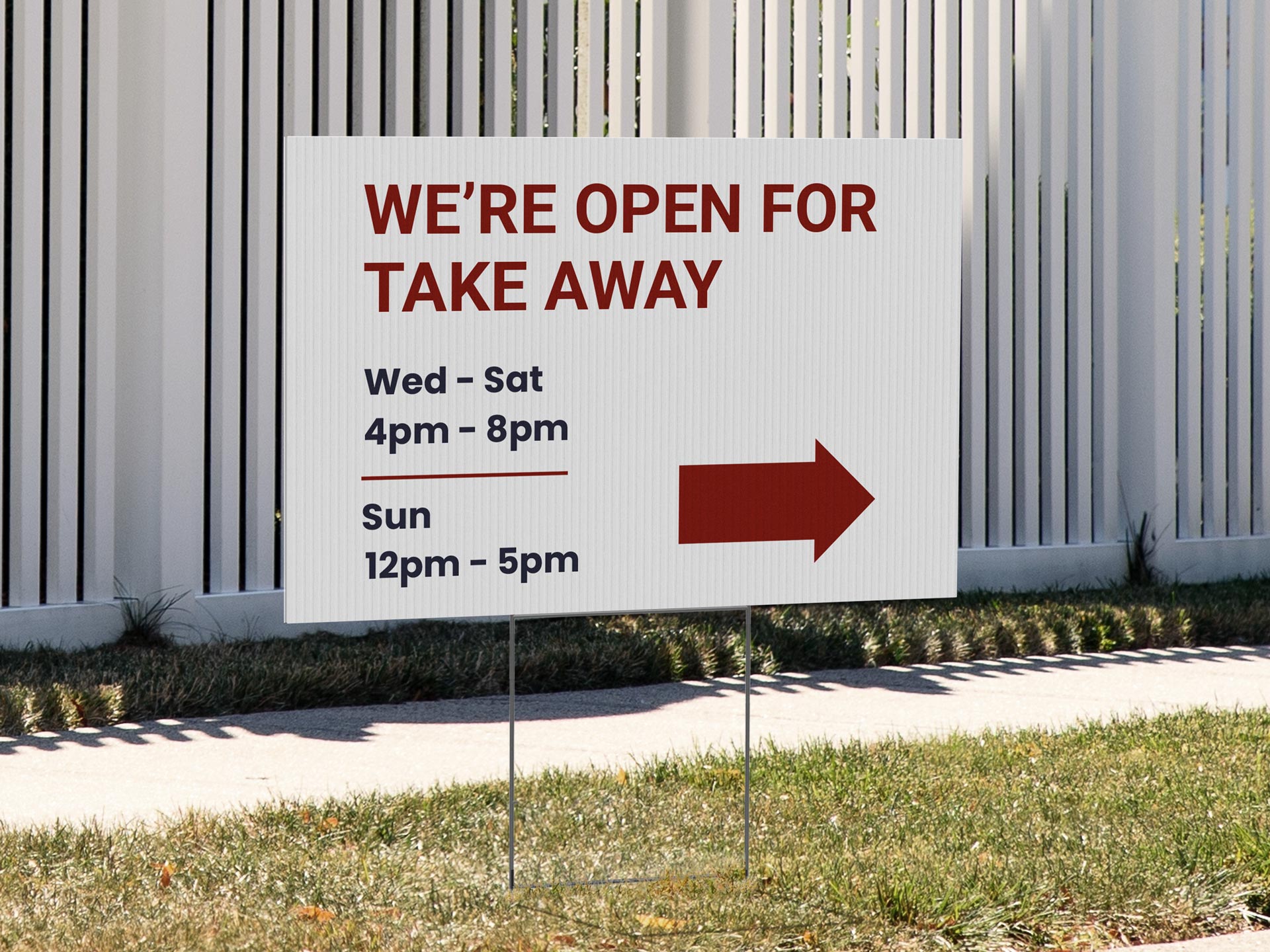 Yard sign advertising takeaway hours with a directional arrow.