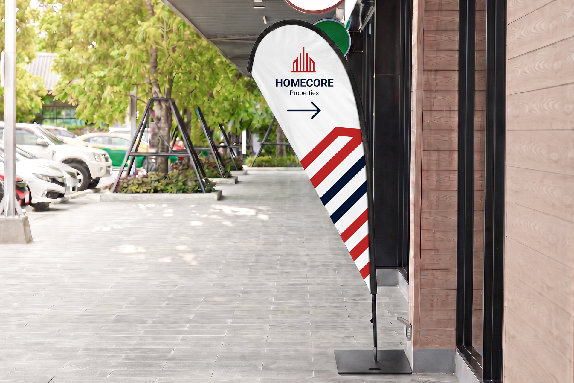 Custom-printed wayfinding teardrop flag with a company logo and an arrow.