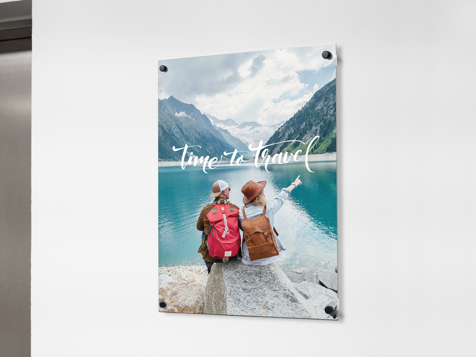 Photo print on acrylic picturing a couple sitting by a mountain lake.