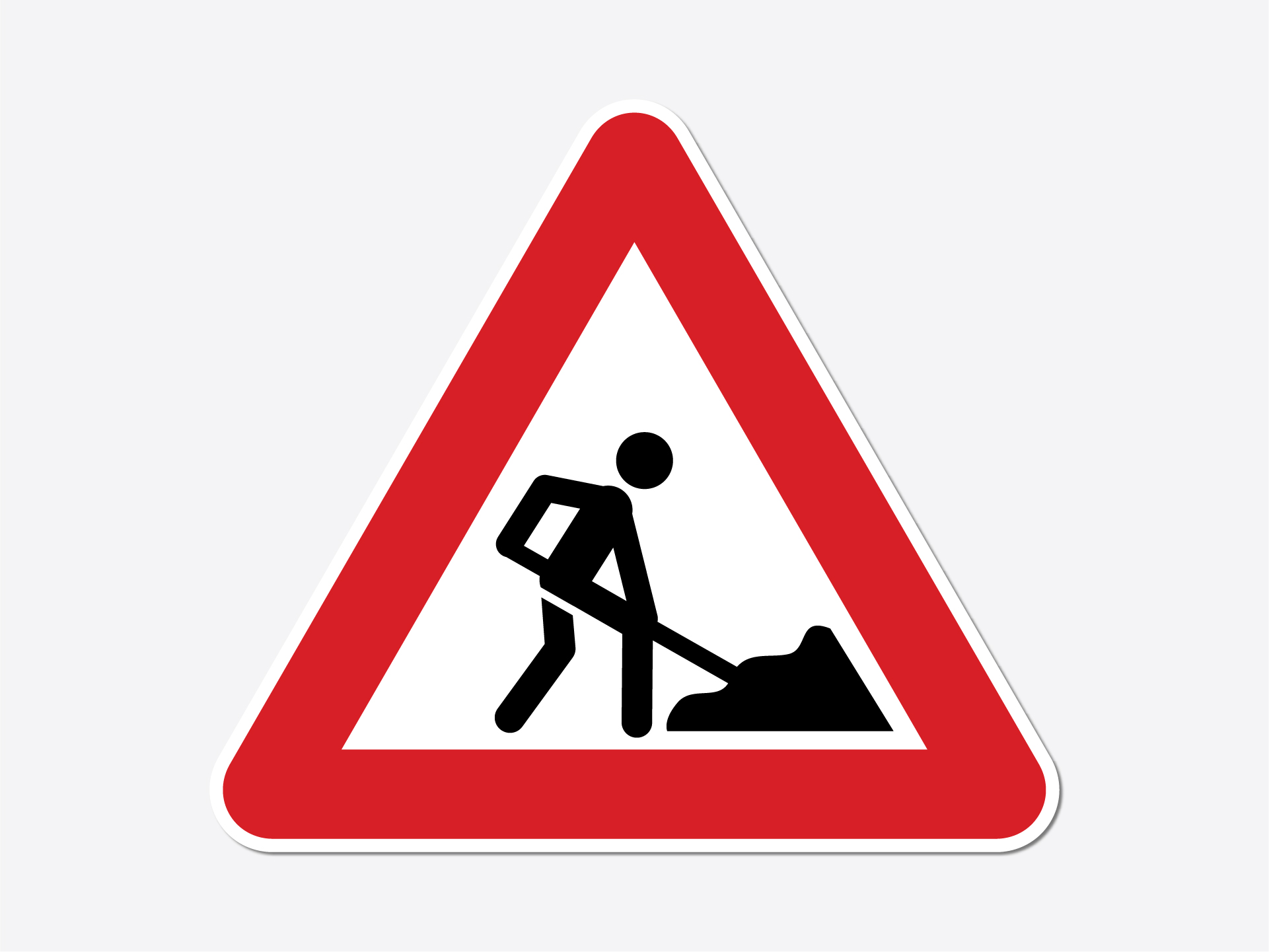Road construction warning sign with worker digging.