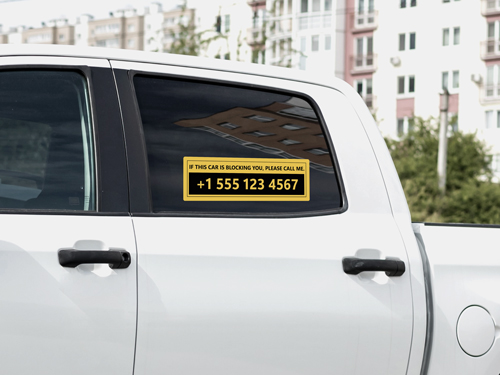 Yellow truck window decal displaying contact number and asking to call, if need be.