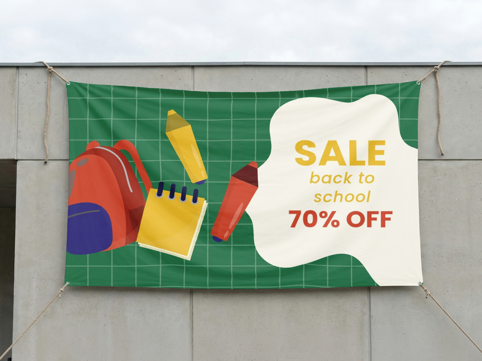 Outdoor vinyl banner showcasing back to school season sales.