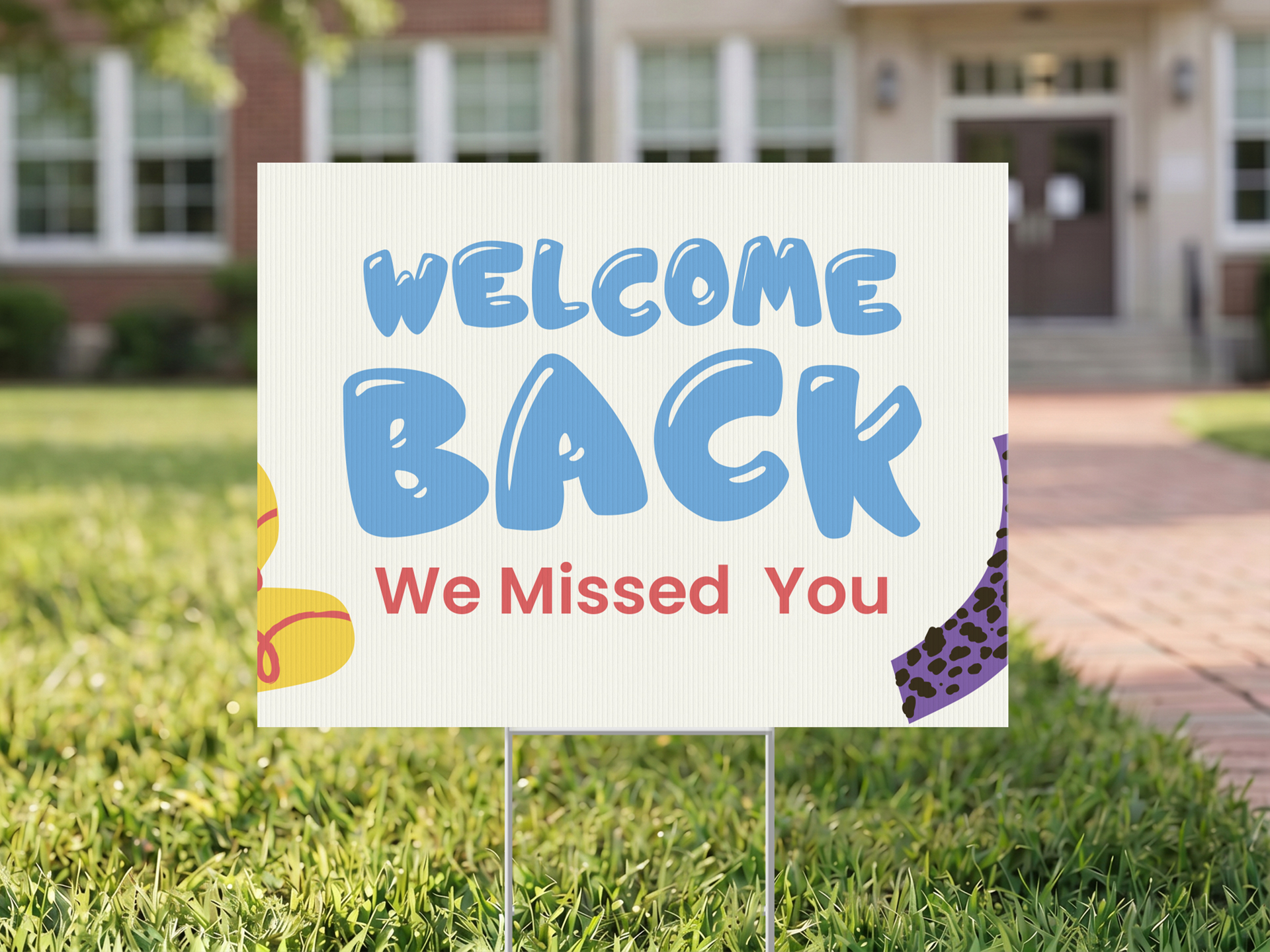 White welcome back yard sign printing installed outdoors.