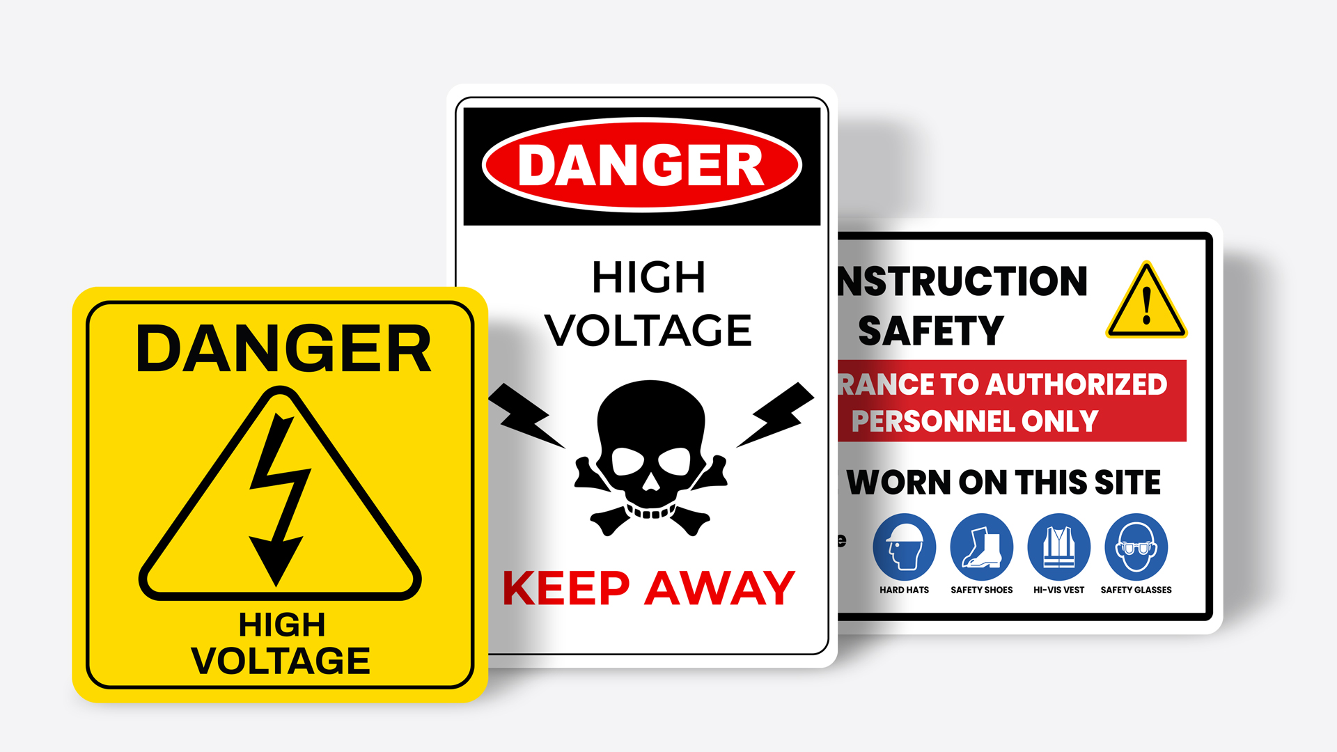 Workplace safety signs for electrical hazards and construction site.